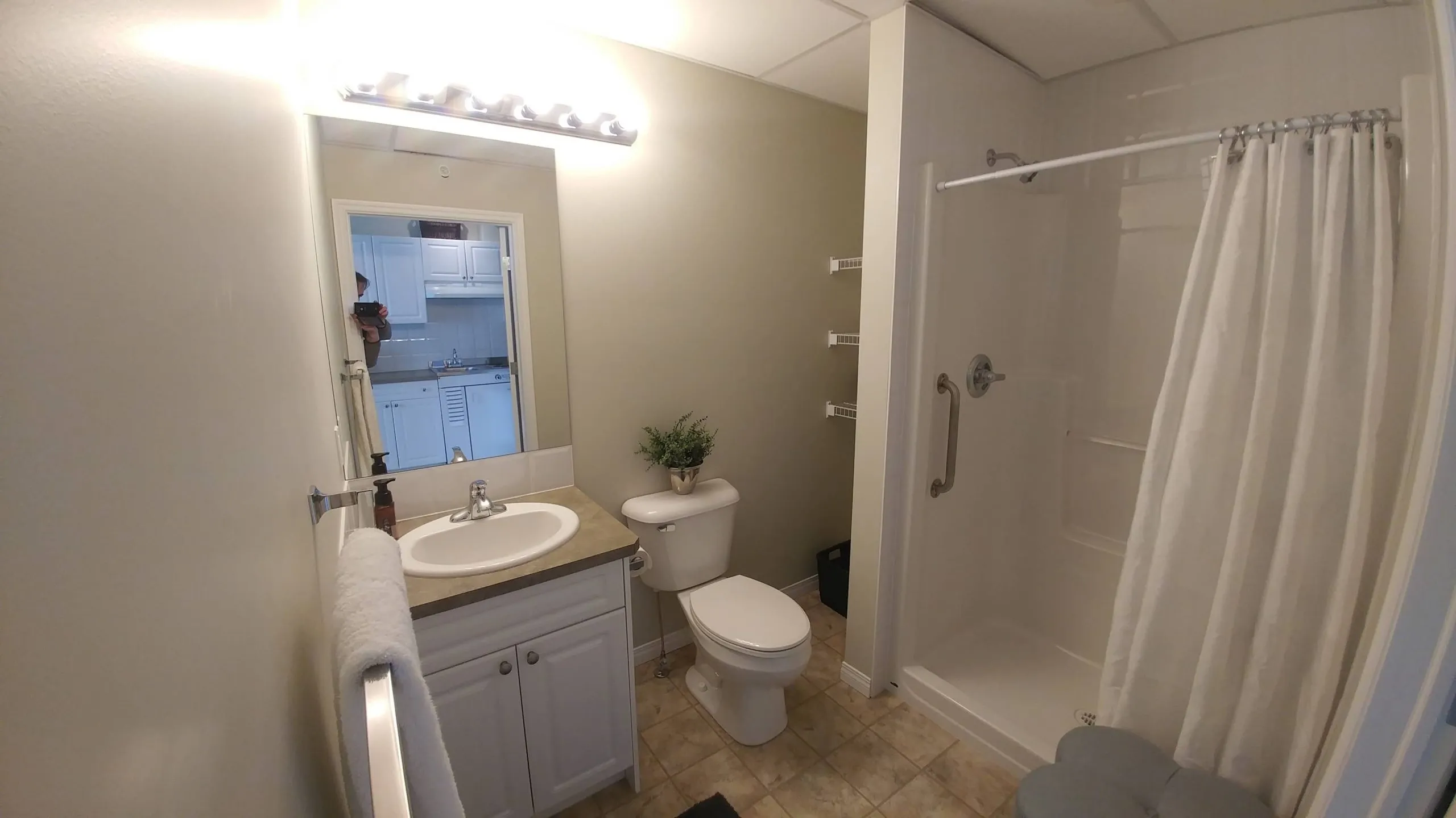 Suite bathroom with a large walk-in shower and grab bar