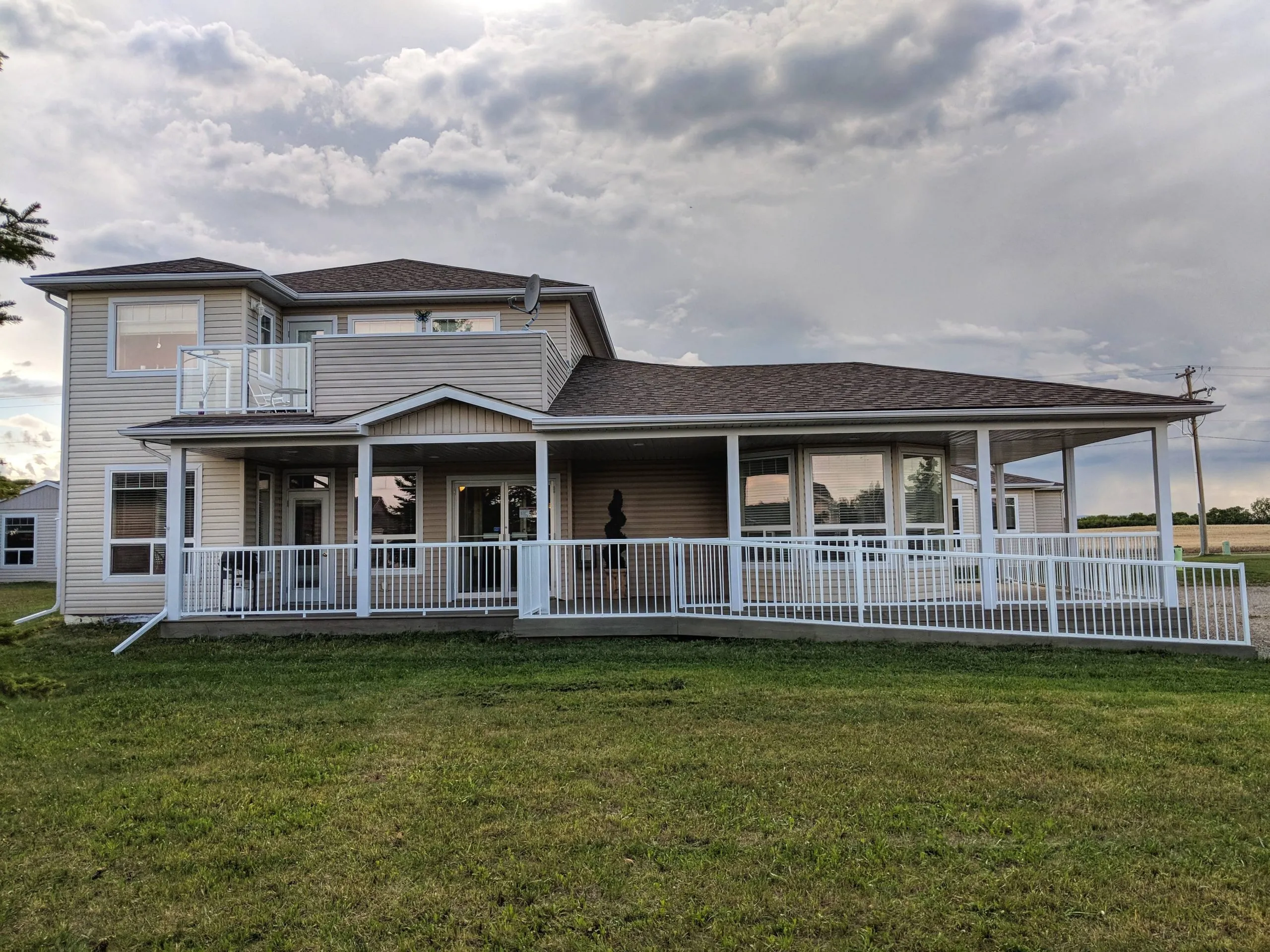 The Freedom Living building with its wraparound veranda, seen across the lawn